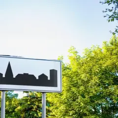 Znak teren zabudowany z sylwetką miasta. Wjeżdżamy do miasta, gdzie czekają nas miejskie krajobrazy.